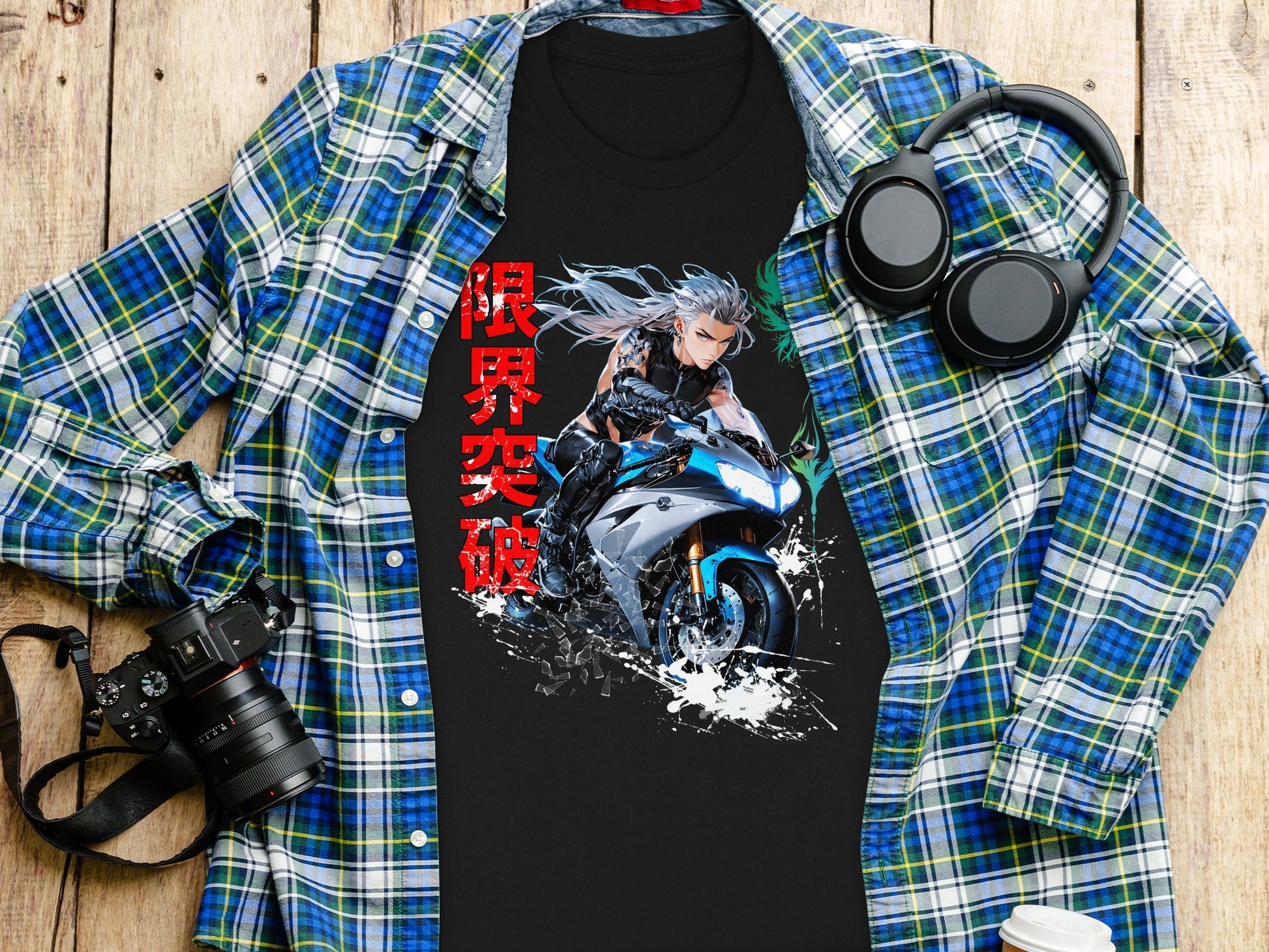 Black t-shirt with graphic of anime motorcyclist and Japanese text, laid on a wooden surface.